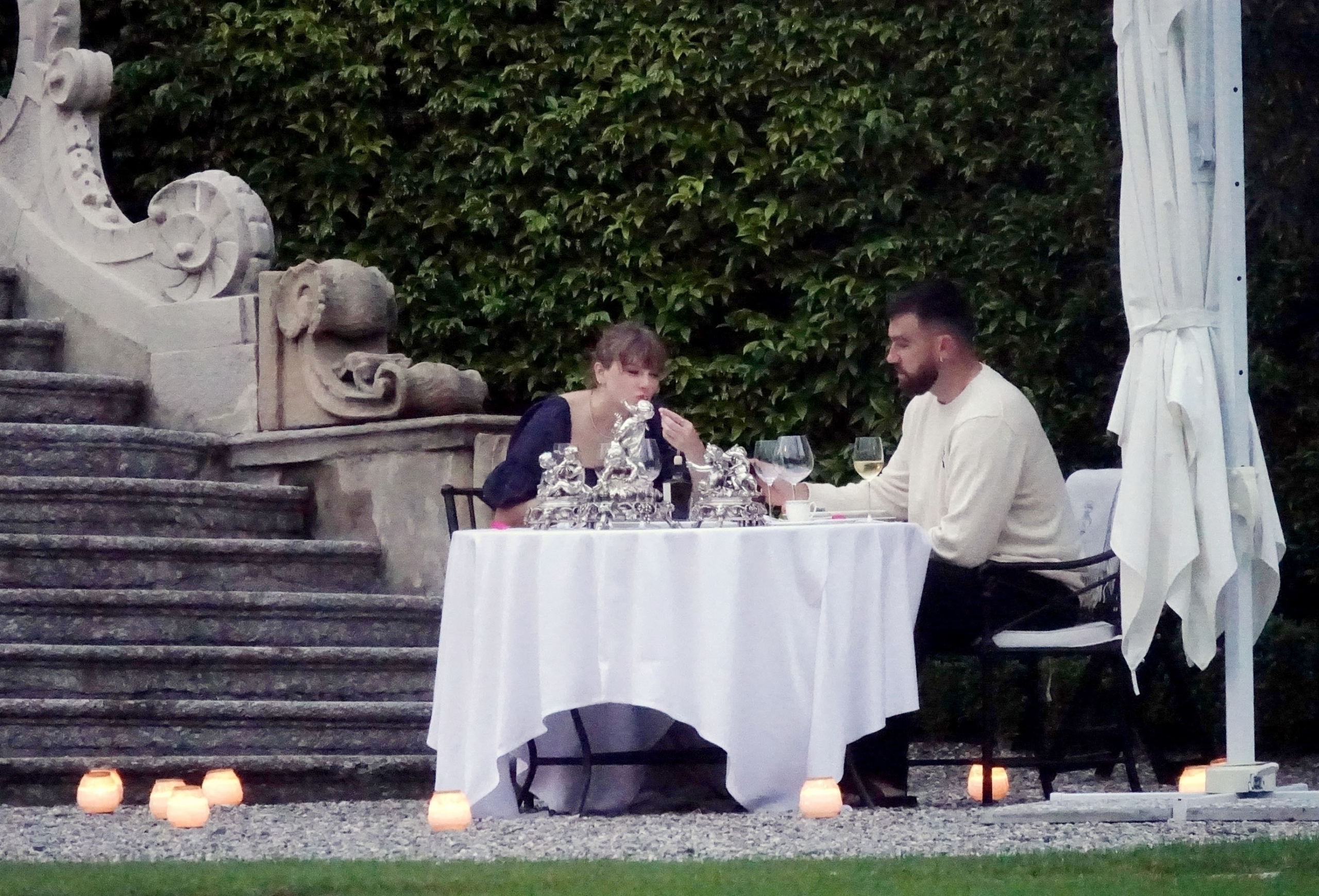 Taylor Swift and Travis Kelce couldn't take their eyes off each other on Monday as they enjoyed a romantic dinner for two on lone table at their private villa in Lake Como: A smitten Taylor gazed adoringly at Travis as they sipped on wine surrounded by candlelight.