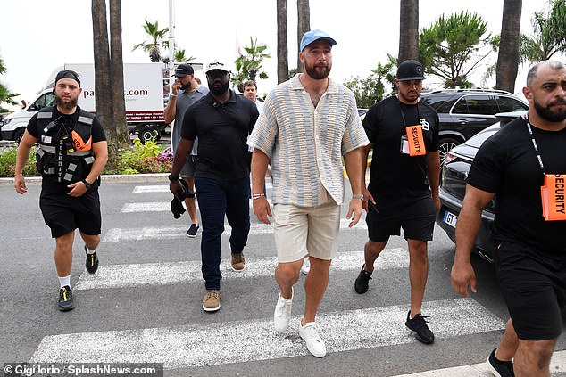 Travis Kelce wears a Fearless friendship bracelet at a Cannes Lions panel as he admits he's got 'more fans' thanks to girlfriend Taylor Swift's VERY dedicated following