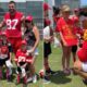 Adorable moment Travis Kelce and Patrick Mahomes make young cancer survivor's day... as superstar Chiefs pair pose for photos - and sign a shirt hailing 'Taylor Swift's boyfriend'