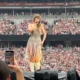 REVEALED: Best Taylor Swift view in the house! Fans agape as figures spotted dancing on the top of Wembley Stadium on the second night of her Eras tour - before arena reveals real reason they were in vertigo-inducing spot